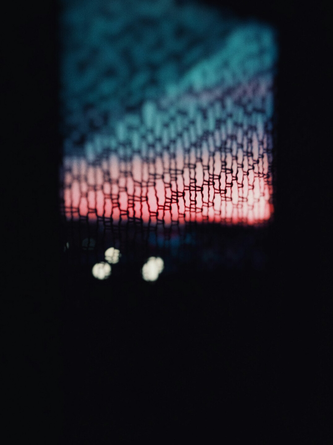 Close-up of a laptop screen displaying colorful code in a dark editor
