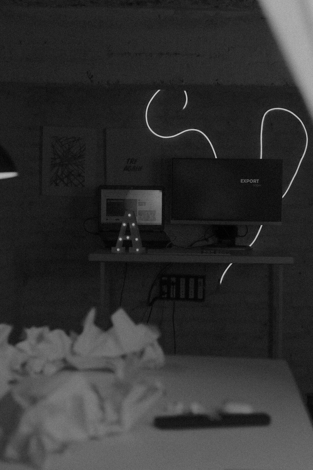 Two computer monitors on a desk showing code and a flowchart diagram